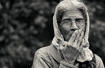 Black and white portrait of an elderly woman with hand over mouth