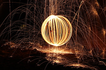 Long exposure steel wool fire spinning art with sparks