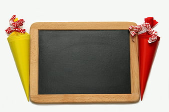 Wooden Chalkboard With Yellow And Red Party Cones On White Background
