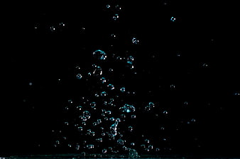 Rising water bubbles on black background