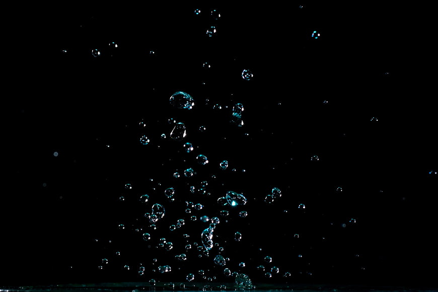 Rising water bubbles on black background