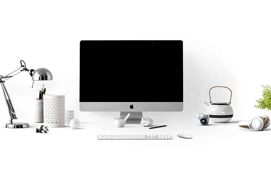 Minimalist White Workspace with Computer Monitor and Accessories