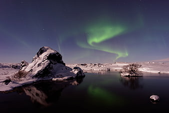 Aurora Borealis over Snowy Winter Lake Landscape