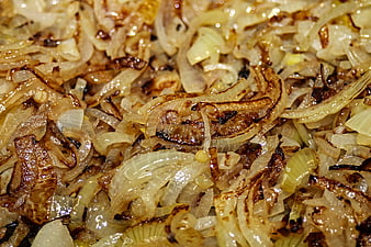Close-up of caramelized roasted onion slices in a pan