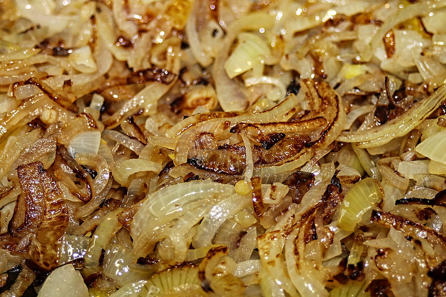 Close-up of caramelized roasted onion slices in a pan
