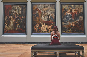 Woman Viewing Classical Paintings in Art Museum Gallery