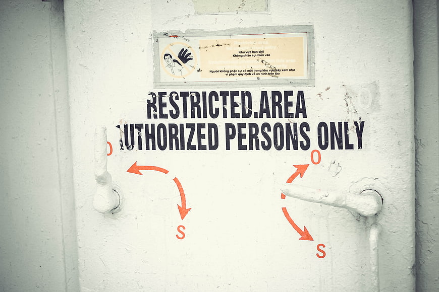 Restricted Area Authorized Persons Only Sign on White Metal Door