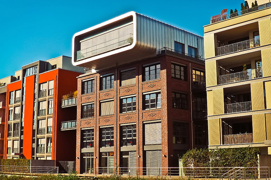 Modern Brick Apartment Building with Unique Overhanging Top Floor