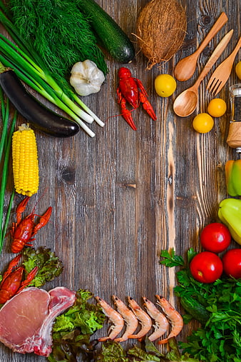 Fresh seafood and vegetables on rustic wooden background