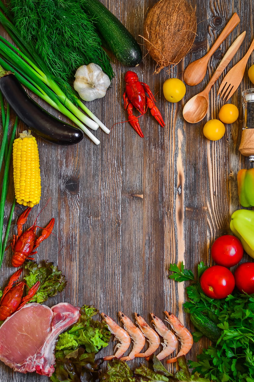 Fresh seafood and vegetables on rustic wooden background