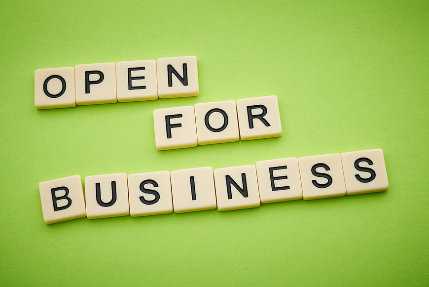 Open for Business Scrabble Tiles on Green Background