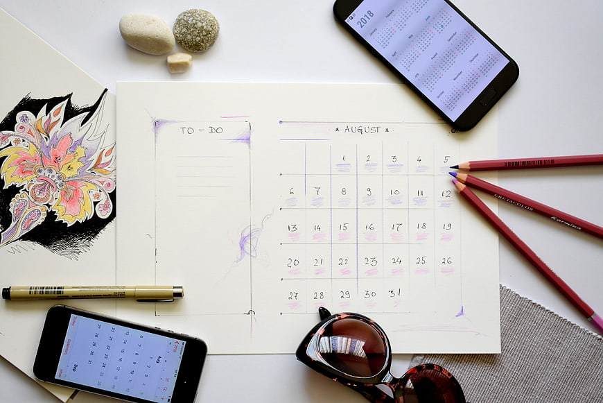 August Vacation Planning Flat Lay With Calendar, To-Do List, and Travel Accessories