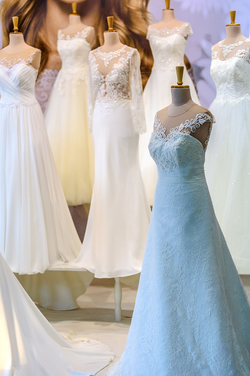 Elegant wedding dress collection displayed on mannequins in bridal boutique