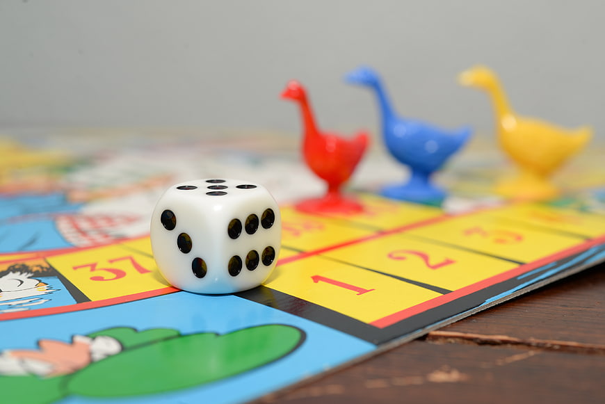 Dice and Goose Game Pieces on Board