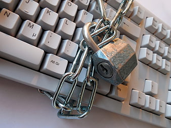 Padlock and Chain on Computer Keyboard Symbolizing Cyber Security