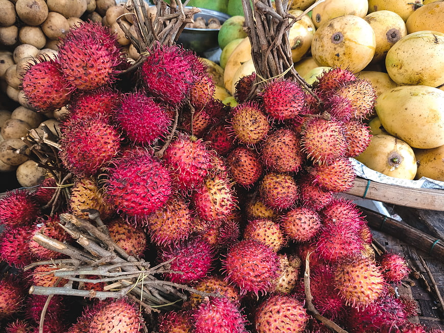 Fresh Red Rambutan Fruit Bunches at Tropical Market