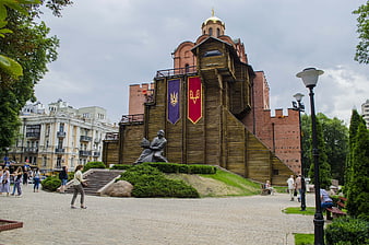 Golden Gate of Kyiv with wooden reconstruction and statue