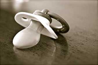 Vintage Black and White Baby Pacifier on Textured Surface