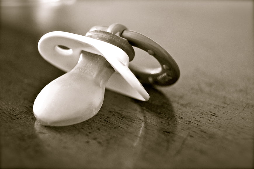 Vintage Black and White Baby Pacifier on Textured Surface