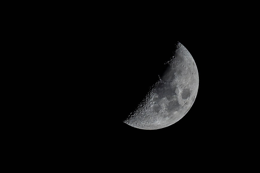 Crescent Moon with Craters Against Black Night Sky