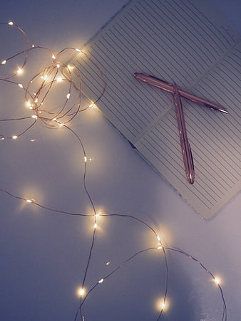 Rose Gold Pens on Notebook with Fairy Lights