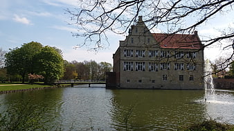 Historic Moated Castle with Fountain and Spring Trees