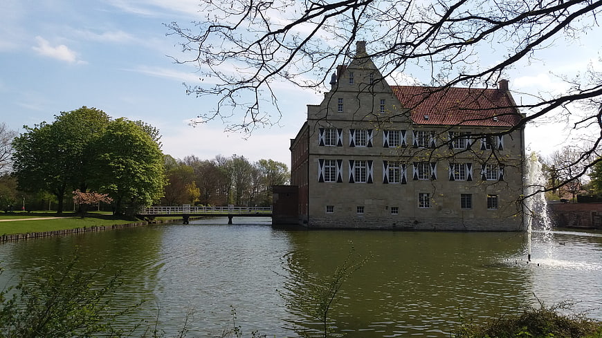 Historic Moated Castle with Fountain and Spring Trees