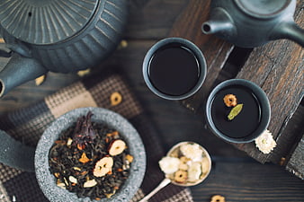 Top view of herbal tea set with loose leaves and dried ingredients