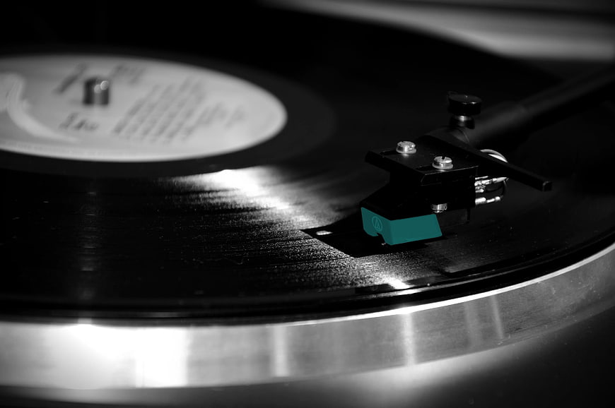 Close-up of vinyl record player with teal cartridge