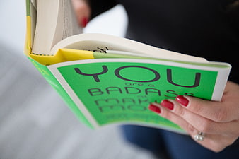 Close-up of Woman Reading Motivational Book