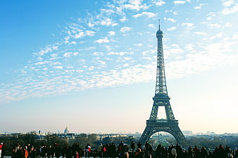 Eiffel Tower in Paris with Tourists and Blue Sky