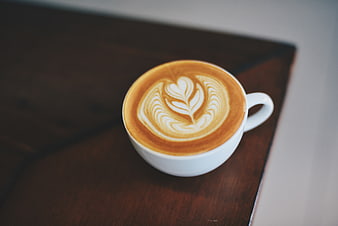 Top View of Cappuccino with Latte Art on Wooden Table