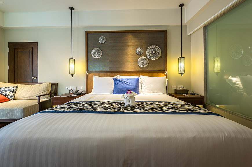 Modern Hotel Bedroom Interior with Wooden Headboard and Blue Accents