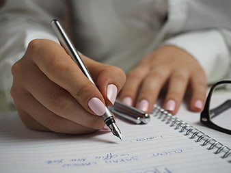 Woman Writing in Notebook with Fountain Pen