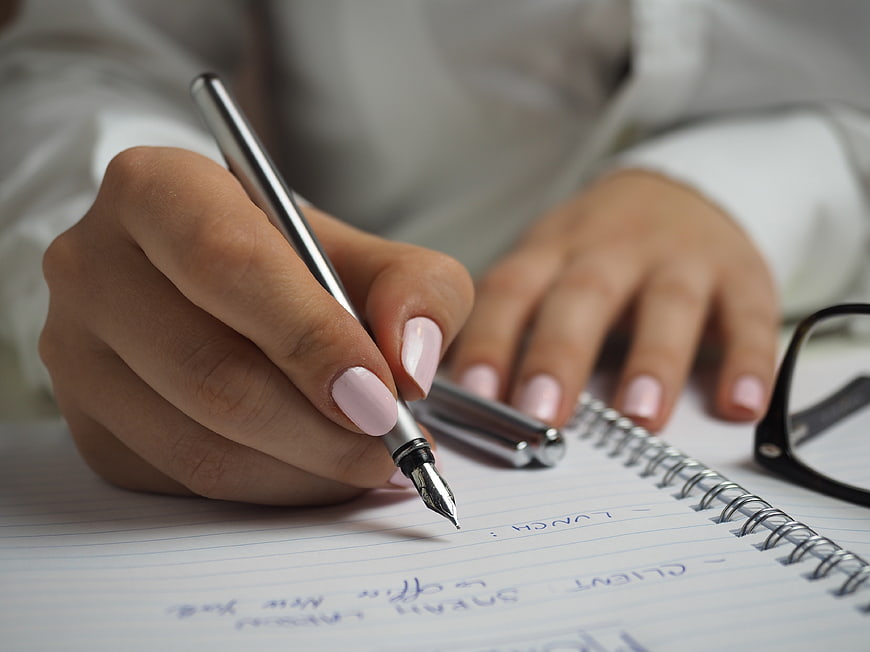 Woman Writing in Notebook with Fountain Pen