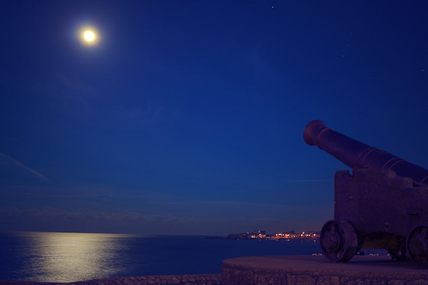 Old Cannon on Fort Wall at Night with Moon and Sea