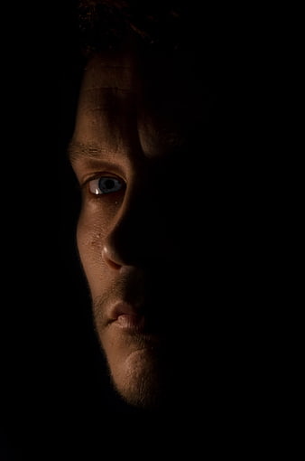 Dramatic Close-Up of Man's Face in Shadow
