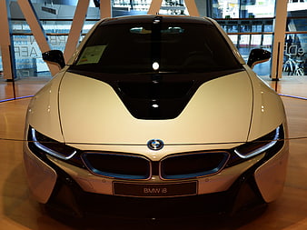 Front view of white BMW i8 sports car in showroom