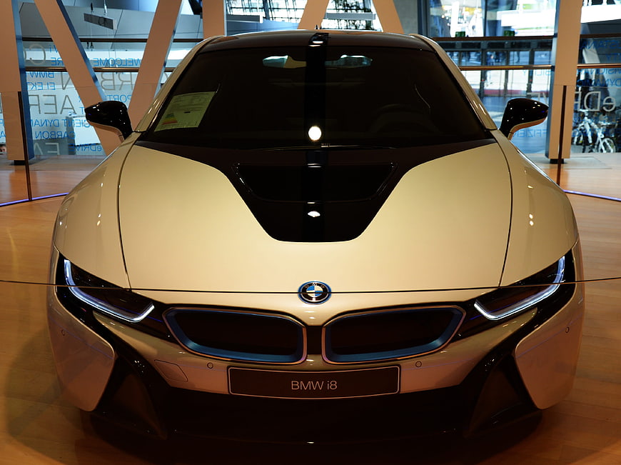 Front view of white BMW i8 sports car in showroom