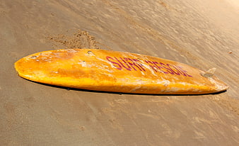 Yellow Surf Rescue Board on Sandy Beach