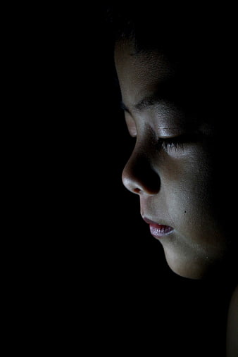 Close-up profile of a sleeping child's face in low light