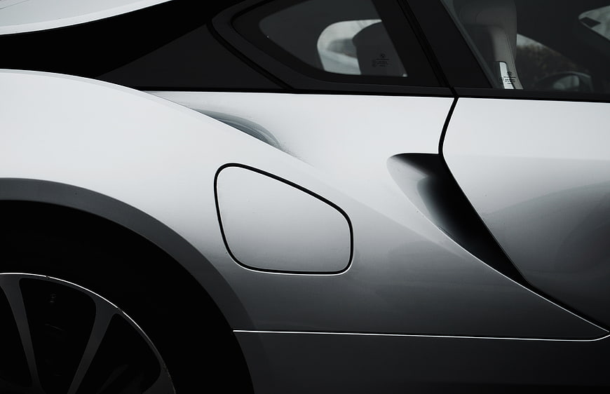 Close-up of white luxury car side panel and fuel cap