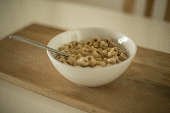 Bowl of Cereal with Milk on Wooden Board