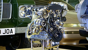 Polished Chrome Car Engine Display with Vintage Cars
