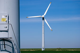 Wind Turbines in Green Field Under Blue Sky