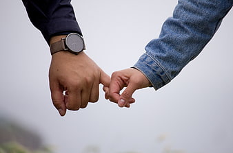 Couple Holding Pinky Promises with Minimalist Watch