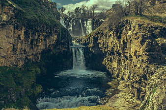 Dramatic Waterfall Cascading Through Rocky Canyon Gorge