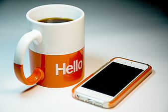 Orange Hello Coffee Mug and Smartphone on White Background