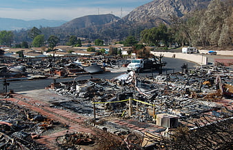 Wide shot of a residential neighborhood devastated by a wildfire
