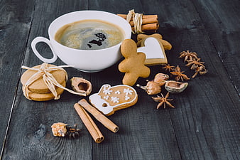Gingerbread cookies and coffee on dark wood